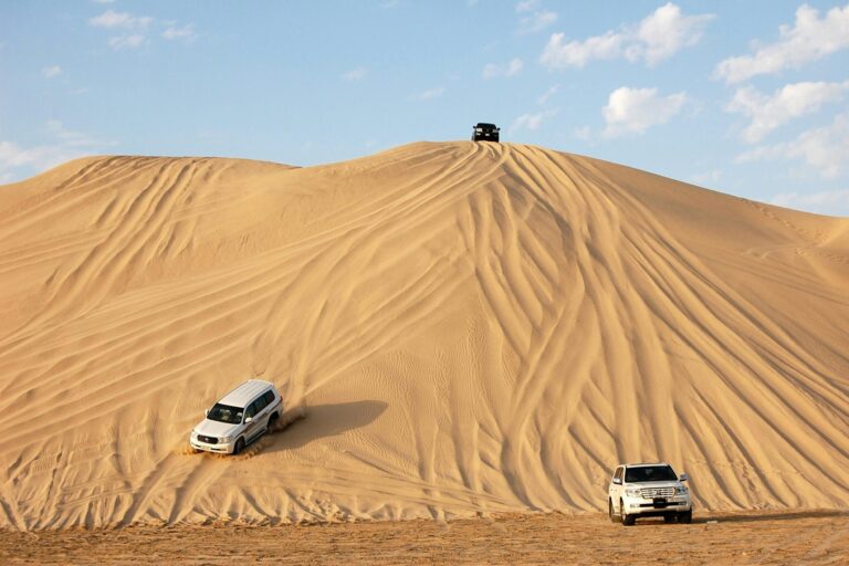 Cars bashing dunes in UAE desert