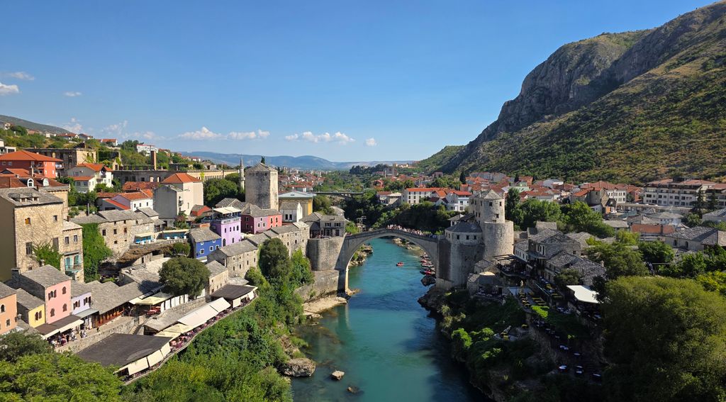 Explore the historic Old Bridge in Mostar, Bosnia and Herzegovina, surrounded by picturesque architecture.